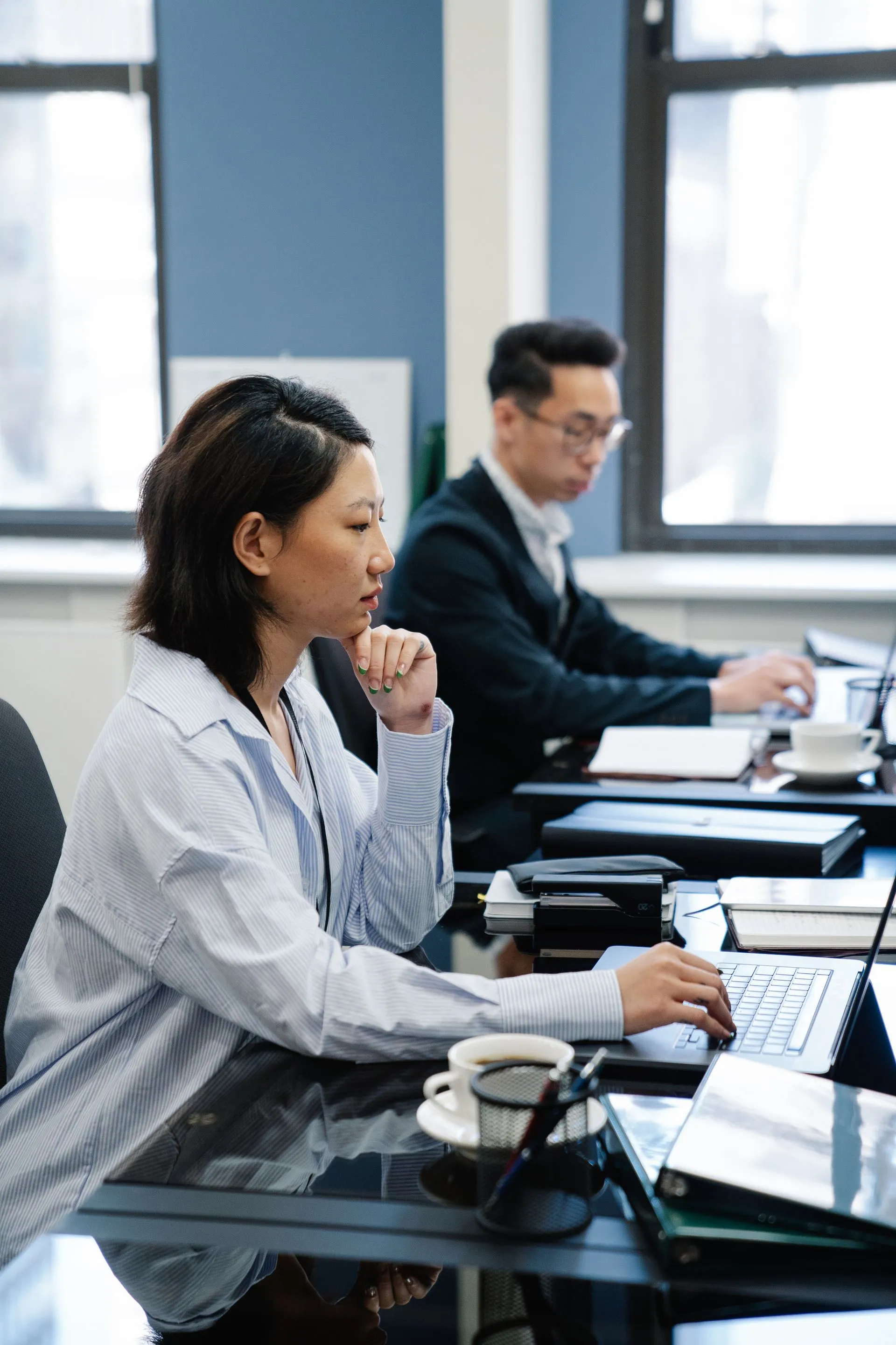 Two colleagues reviewing a contract together on a laptop at a meeting table